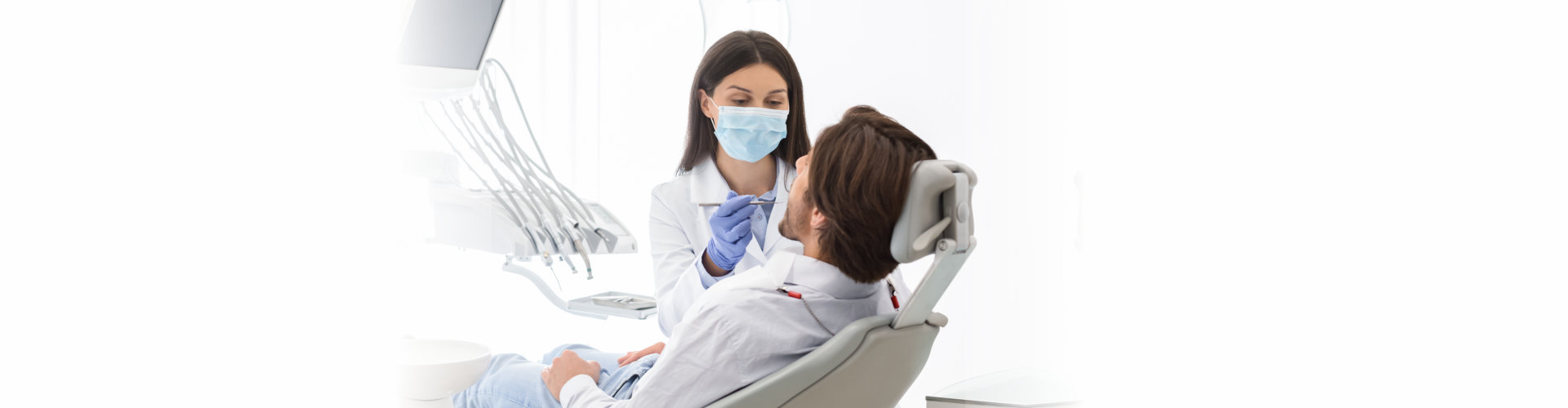 Female dentist making check up for patient in dental clinic